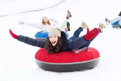 smiling girl snow tubing